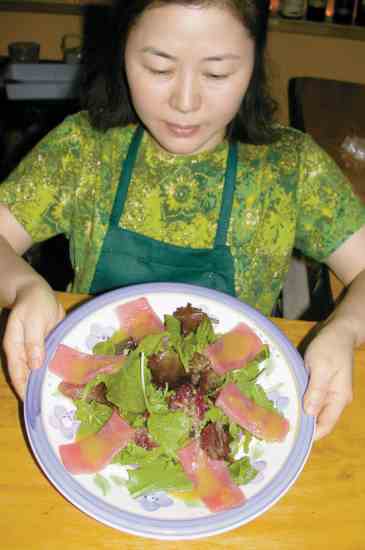 
Jenny Shin, kitchen chef at Wa in Lawrence, Kan., prepares tuna salad with wasabi sauce.
